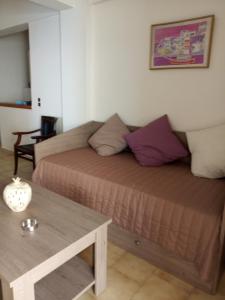 a bedroom with a bed and a table in a room at Buganvilla Sea View apts in Agia Pelagia