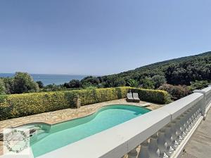 a swimming pool on the balcony of a house at Seaview villa Marlau in Macinaggio