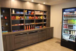 a store aisle with a large refrigerator with drinks at Holiday Inn Express & Suites - Enterprise, an IHG Hotel in Enterprise