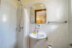 a bathroom with a sink and a mirror at Lantern apartments in Marsalforn
