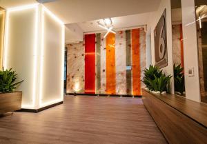 an empty lobby with a colorful wall with plants at No 6 Apartments in Constanţa