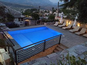 a swimming pool on top of a house at Boutique Hotel Praga in Gjirokastër