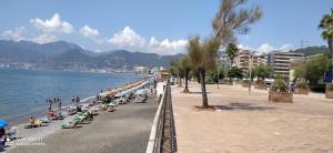 a beach with a bunch of people sitting on beach chairs at civico sei rooms in Salerno