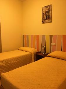 Postel nebo postele na pokoji v ubytování Hotel Vezzano