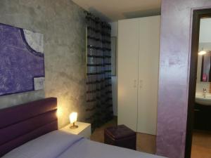 a bedroom with a bed with a lamp and a sink at Busalacchi B&B in Mondello