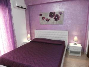 a purple bedroom with a bed and two night stands at Busalacchi B&B in Mondello