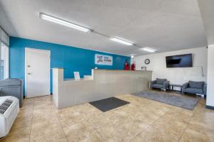 a hospital room with a blue wall and a waiting area at Zen Living Suites Extended Stay - Jacksonville - Orange Park in Orange Park