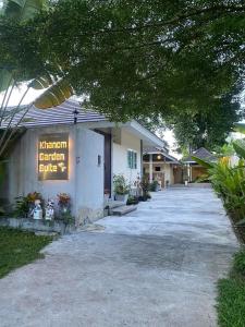 a building with a sign on the side of it at Khanom Garden Suite in Khanom