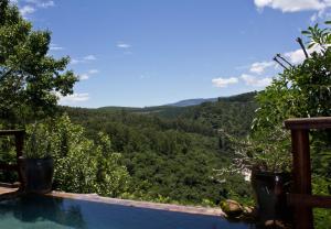 a swimming pool with a view of the mountains at Tanamera Lodge in Hazyview