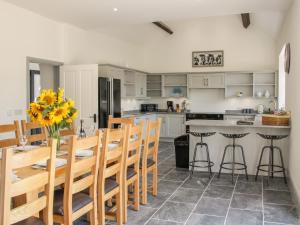 a kitchen and dining room with a table and chairs at The Farm in Presteigne