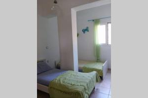 a bedroom with two beds and a window at Mina's Kypri Apartment in Kipri