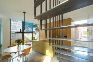a kitchen and dining room with a table and a staircase at Kaewkong Surf Motel in Scheveningen
