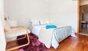 a bedroom with a white bed and a purple rug at Midway to Geres and Braga in Amares