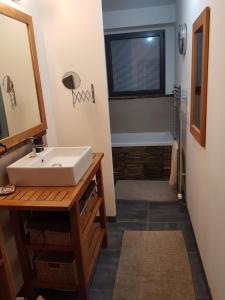 a bathroom with a sink and a bath tub at Escapade Amiens in Amiens