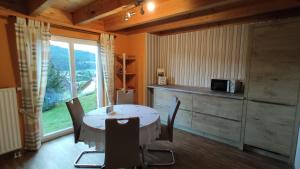 a kitchen with a table with chairs and a microwave at Ferienwohnung Albblick in Albstadt