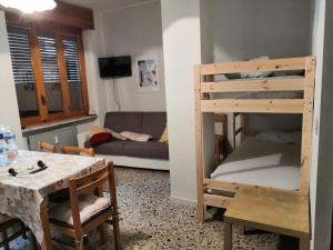 a living room with a bunk bed and a table at da Alessandra e Fabio in Miroglio