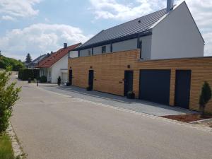 a building with two garage doors and a driveway at Ferienwohnung Daudi in Bad Dürrheim