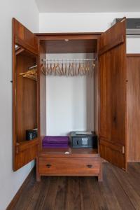 a wooden cabinet with a radio in a room at Hotel Lug in Osijek