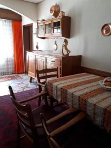 a kitchen with a table and a table and chairs at Casa Romana in Someo