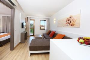 a living room with a bed and a couch at Apartamentos Jade in Playa de Palma