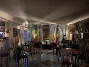 a restaurant with tables and chairs in a room at Black Market Hotel in Ischia Town