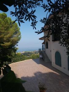 a building with a staircase leading up to it at Panacea la casa del miele in Santa Maria di Castellabate