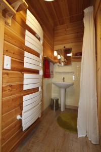 a bathroom with wooden walls and a sink and a shower at Le Martagon in Vars +65 photos