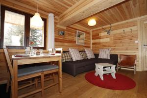 a living room with a couch and a table at Le Martagon in Vars