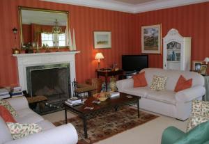 a living room with a couch and a fireplace at Kirklands House Melrose Bed and Breakfast in Melrose