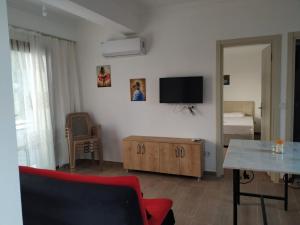 a living room with a red couch and a tv at EVALiN in Mugla