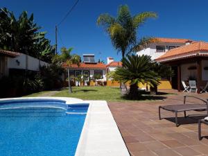 a swimming pool in front of a house at Casita La Finca II in Breña Baja
