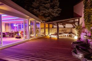 a house with a deck at night at #1 Luxury Villa with Pool, Gameroom, Spa, Zen Yard in Belgrade