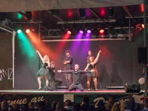 a group of people on a stage in front of a crowd at GRS Mobil Home in Onzain