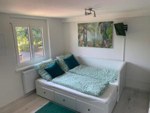 a small room with a bed with blue pillows at Greenhome in Weil am Rhein