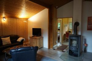 a living room with a couch and a wood stove at Ferienhaus Schneeberger in Winsen Aller