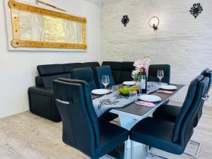 a dining room with a table and blue chairs at Apartament Rodzinny Centrum Zakopane in Zakopane