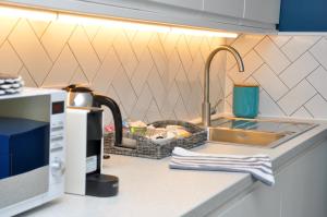 a kitchen counter with a sink and a microwave at Bridge Street Apartments. Boutique Style Luxury, in the heart of Taunton. in Taunton