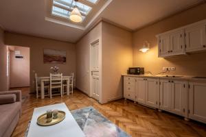 a kitchen and living room with a couch and a table at Rendez-vous Apartment in Sighişoara +10 photos