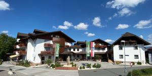 a group of buildings in a parking lot at Hotel Königgut in Wals