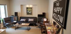 a living room with a couch and a chalkboard at The Happy Hollow in Hot Springs