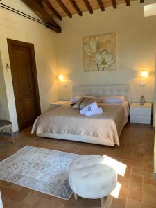 a bedroom with a large bed and a stool at Domus Clara in Assisi +28 photos