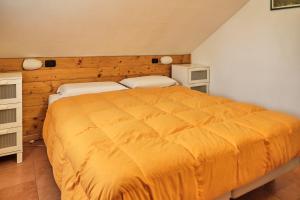 a bedroom with a large yellow bed in a room at Residence SoleNeveSila B&B in Camigliatello Silano +26 photos