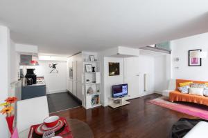 a living room with a couch and a television at My London Holiday Home in Woolwich