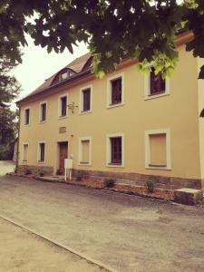 a large white building with windows on a street at Zur alten Post Zittau in Zittau