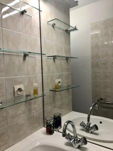 a bathroom with a sink and a glass shower at Moulis in Hourtin