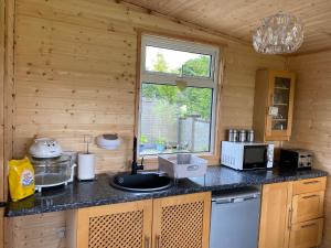 a kitchen with a counter with a sink and a window at Elagh View Bed & Breakfast in Derry Londonderry