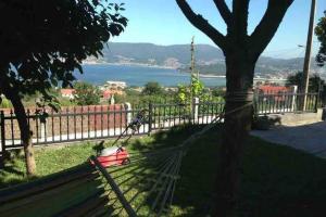 a park bench with a view of the water at Casamary in Pontevedra