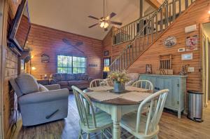 a dining room with a table and chairs and a staircase at Charming Branson Getaway with Fireplace and Porch in Branson