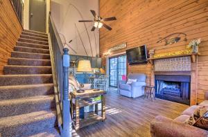 a living room with a staircase and a fireplace at Charming Branson Getaway with Fireplace and Porch in Branson