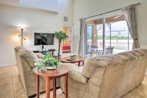 a living room with a couch and a table at Colorful Family Villa with Game Room, 8 Mi to Disney in Kissimmee